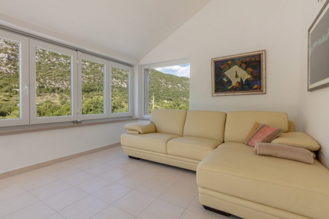 Comfortable sofa at the living room in the Villa Roglic with the view on beautiful mountain Biokovo